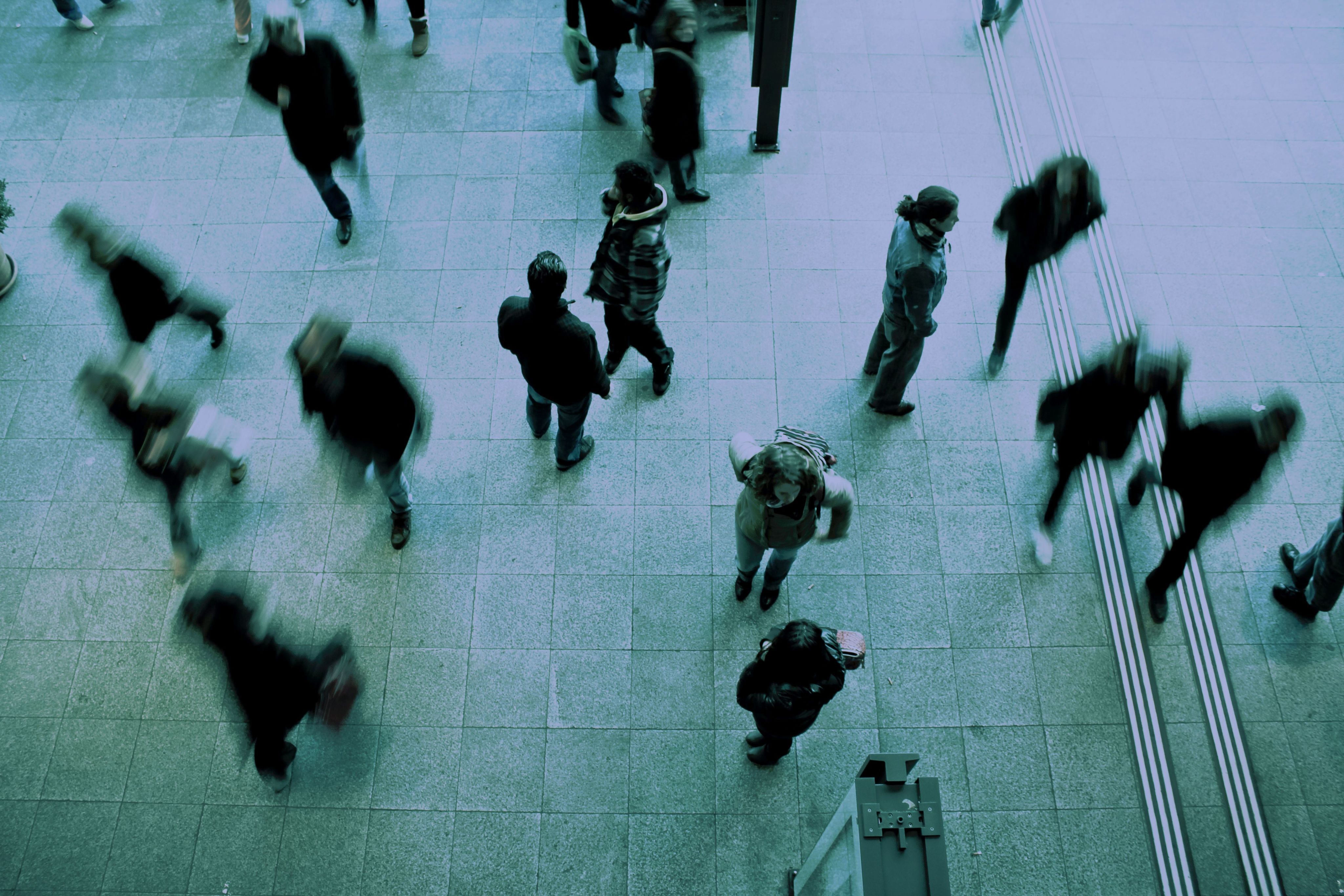 people walking on grey concrete floor during daytime